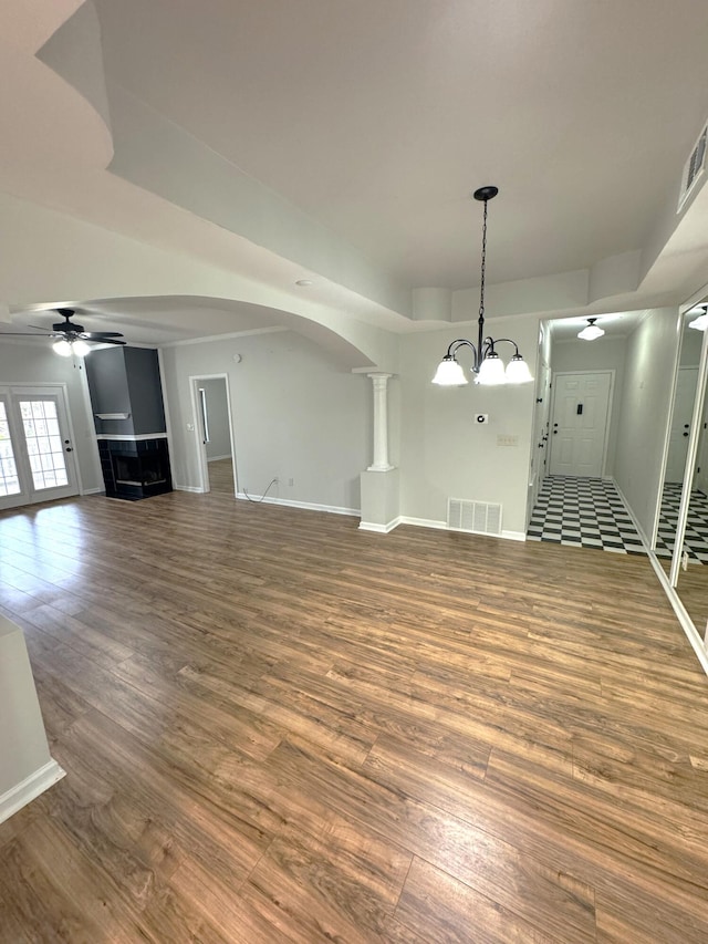 interior space featuring hardwood / wood-style floors and ceiling fan with notable chandelier