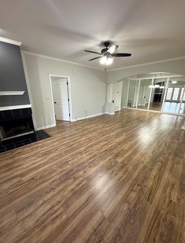 unfurnished living room featuring ornamental molding, wood-type flooring, and ceiling fan