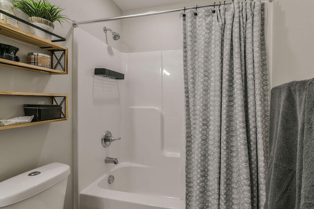 bathroom with shower / bath combination with curtain and toilet