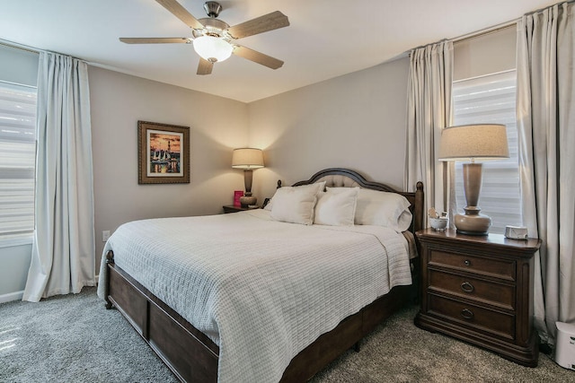 bedroom featuring ceiling fan, multiple windows, and carpet floors