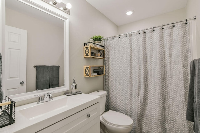 bathroom with toilet and vanity