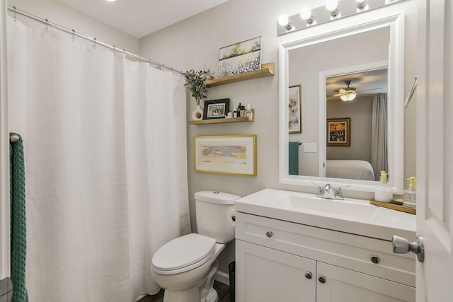 bathroom with toilet, vanity, and ceiling fan