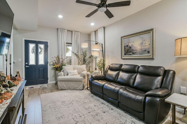 living room featuring hardwood / wood-style floors and ceiling fan