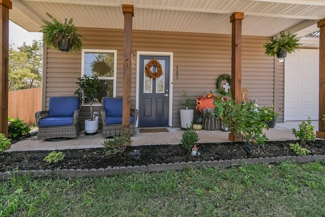 view of exterior entry with a porch