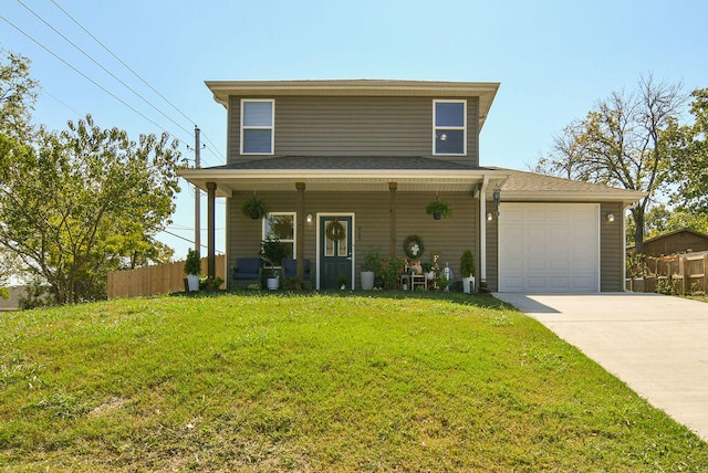 view of front of home with a garage, a front lawn, and covered porch