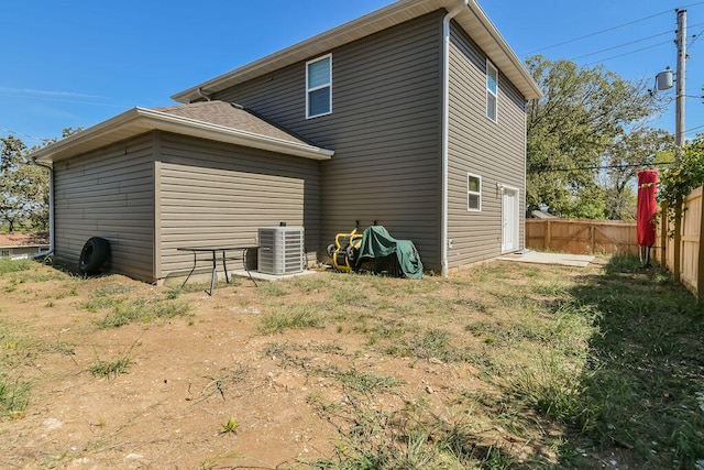 back of house with central AC