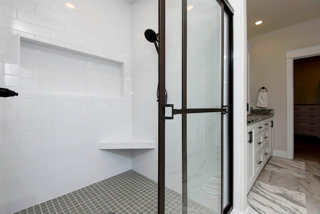 bathroom featuring an enclosed shower and vanity