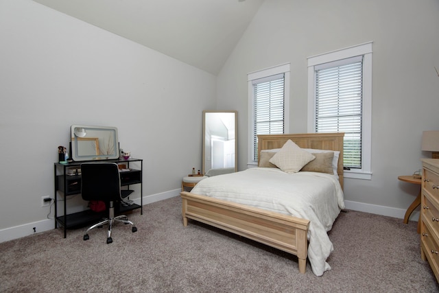 carpeted bedroom featuring high vaulted ceiling