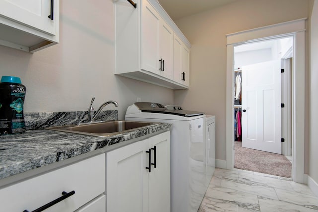 washroom with washing machine and dryer, cabinets, sink, and light colored carpet