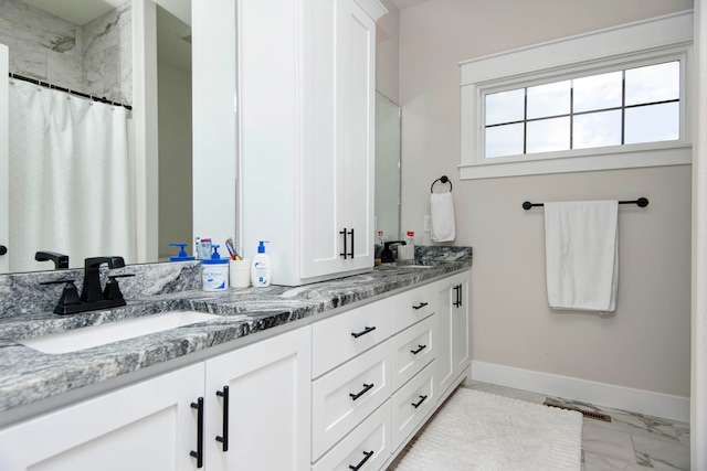 bathroom featuring vanity and curtained shower