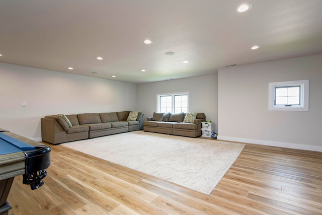 living room featuring pool table and light hardwood / wood-style floors