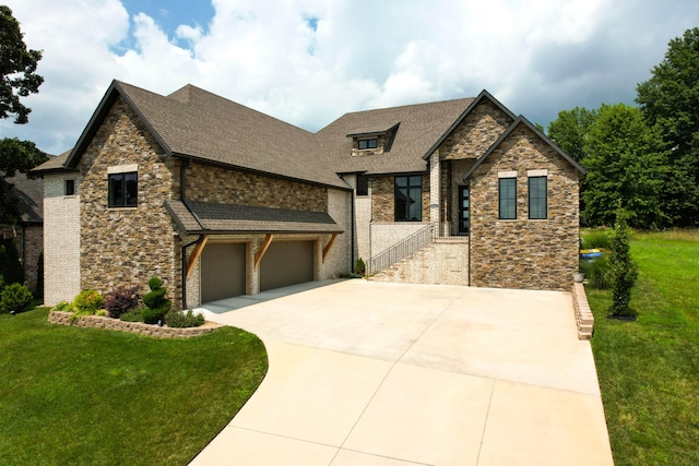 view of front of property featuring a garage and a front lawn