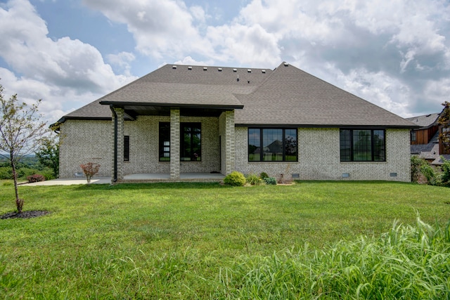 rear view of property with a patio and a yard