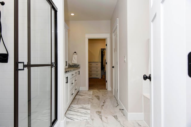 bathroom with walk in shower and vanity