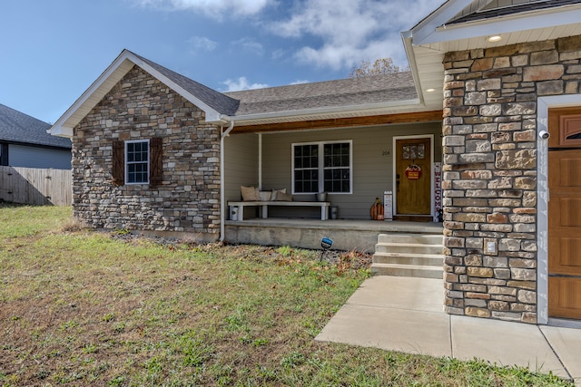 view of front of house with a porch and a front yard