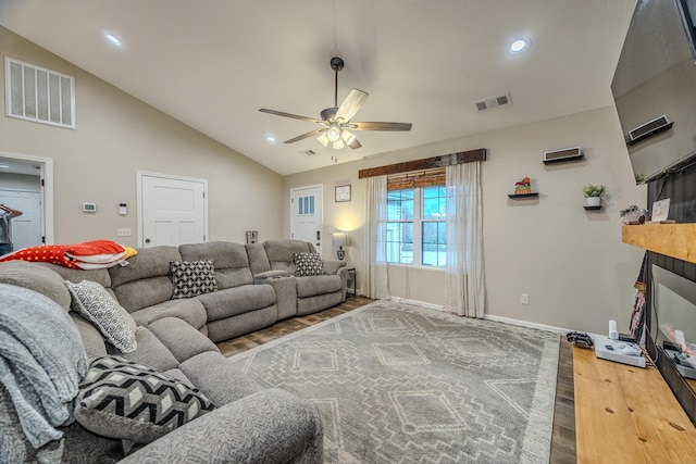 living room featuring lofted ceiling, hardwood / wood-style flooring, and ceiling fan