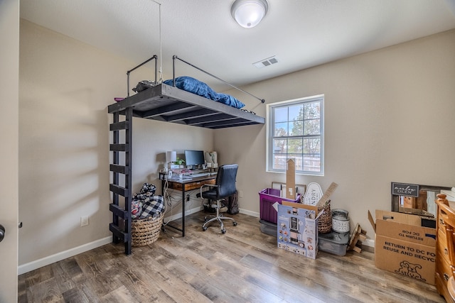 bedroom featuring wood-type flooring