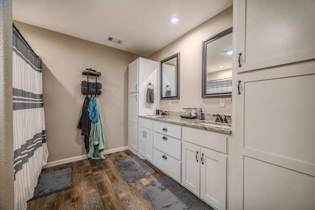 bathroom featuring vanity and hardwood / wood-style floors