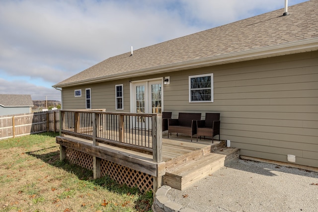 back of property with a yard and a deck