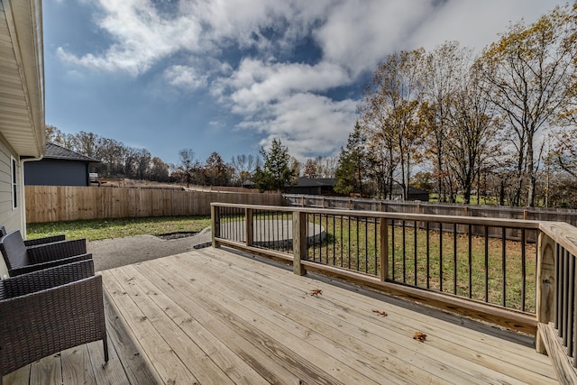 wooden terrace featuring a lawn