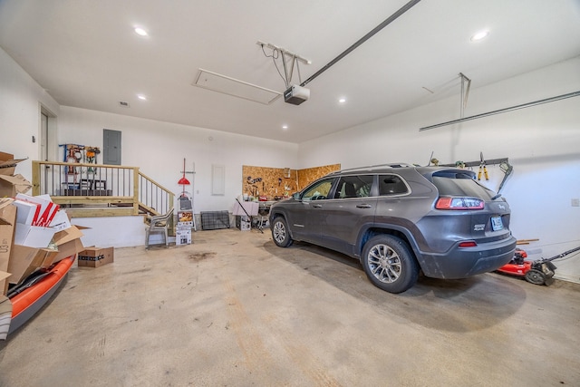 garage featuring electric panel and a garage door opener