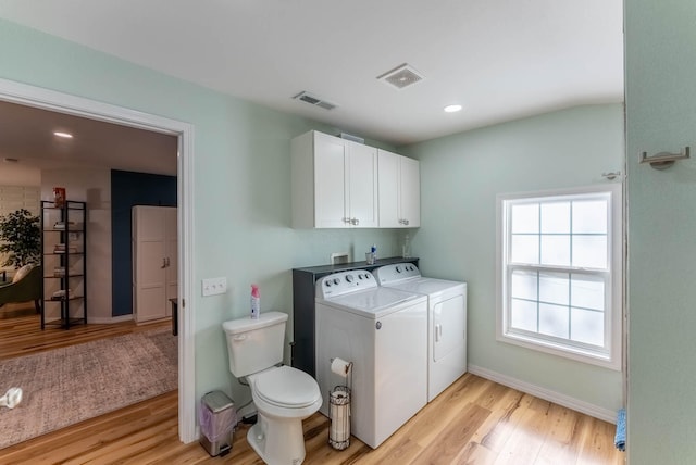 laundry area featuring light hardwood / wood-style floors and washer and dryer