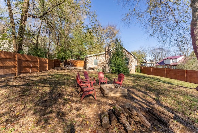 view of yard with a fire pit