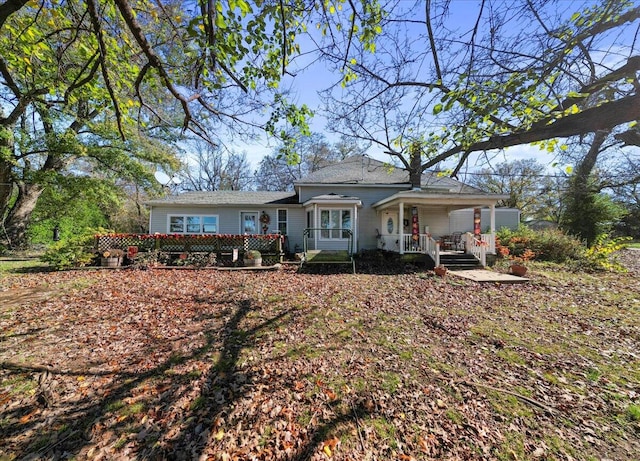 back of property featuring covered porch