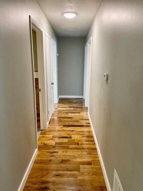 corridor featuring light wood-type flooring