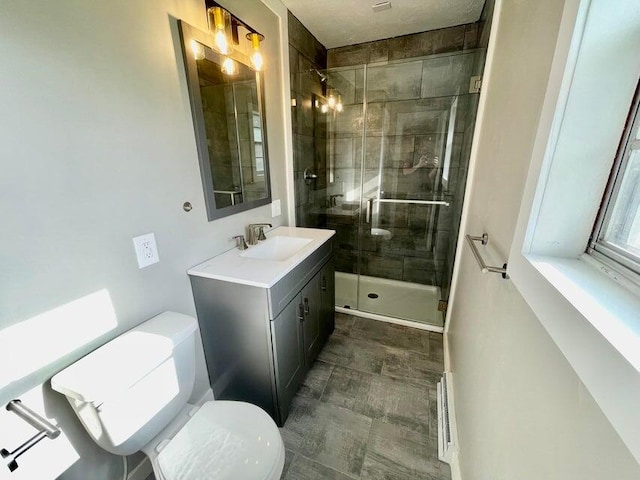 bathroom with walk in shower, vanity, and toilet