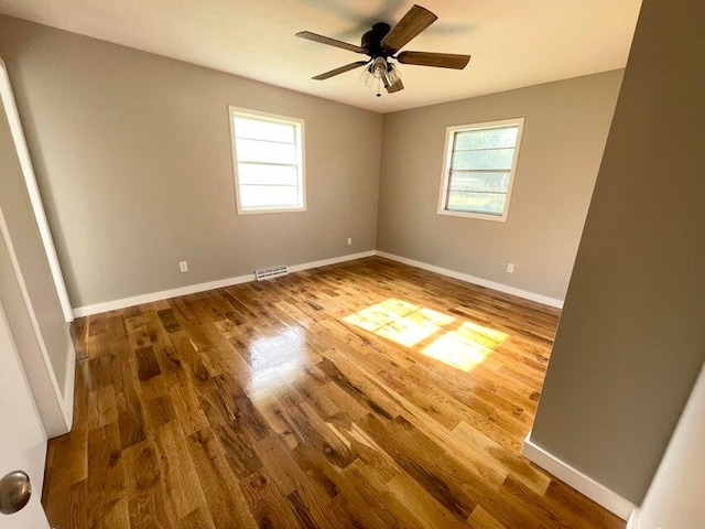 unfurnished room with hardwood / wood-style flooring and ceiling fan