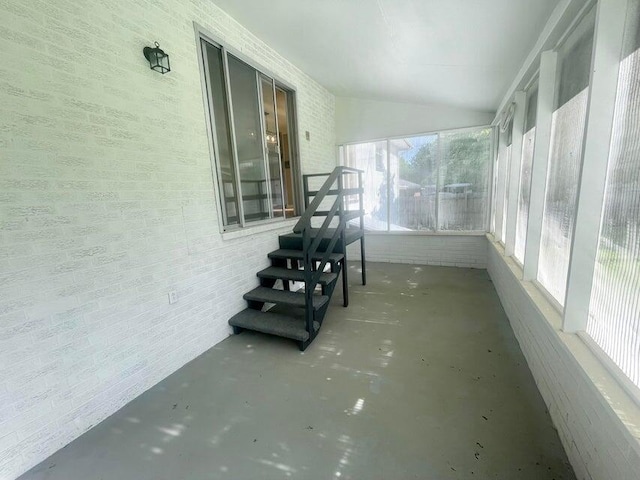 unfurnished sunroom with vaulted ceiling