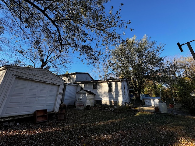 exterior space with a garage and an outdoor structure