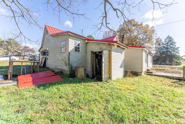 view of side of home with a yard