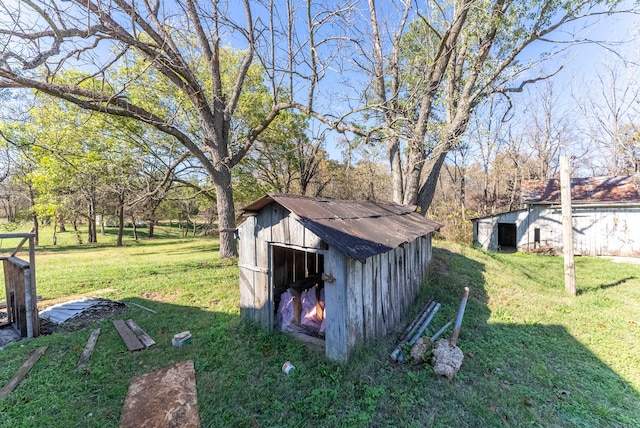 view of outbuilding featuring a yard