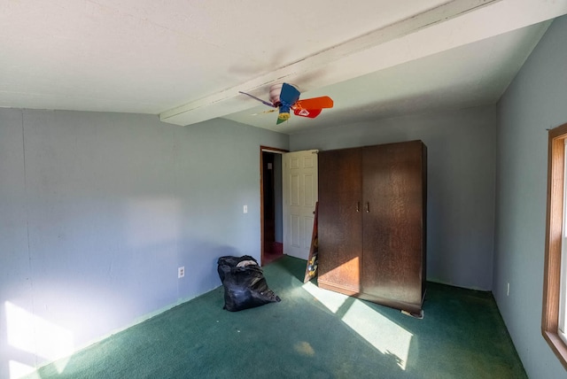 unfurnished bedroom featuring ceiling fan and carpet floors