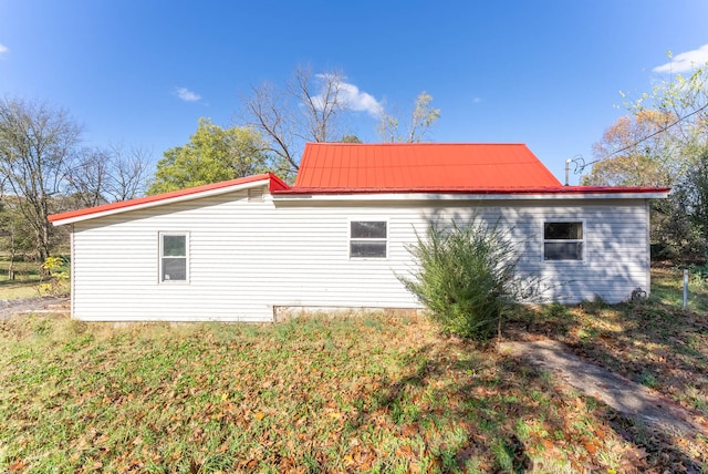 view of side of home featuring a lawn