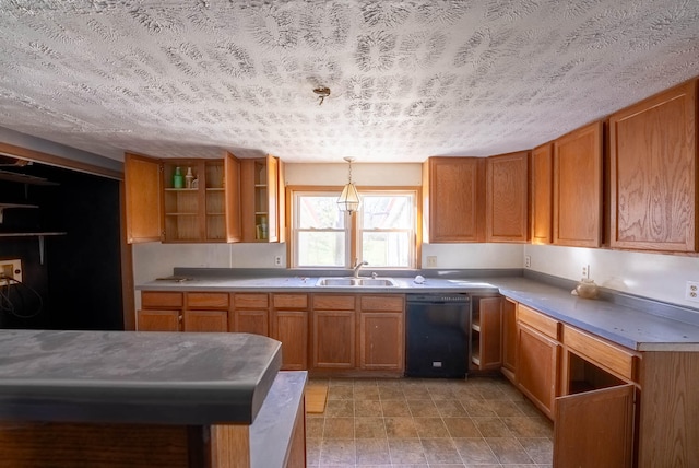 kitchen with a textured ceiling, sink, pendant lighting, and dishwasher