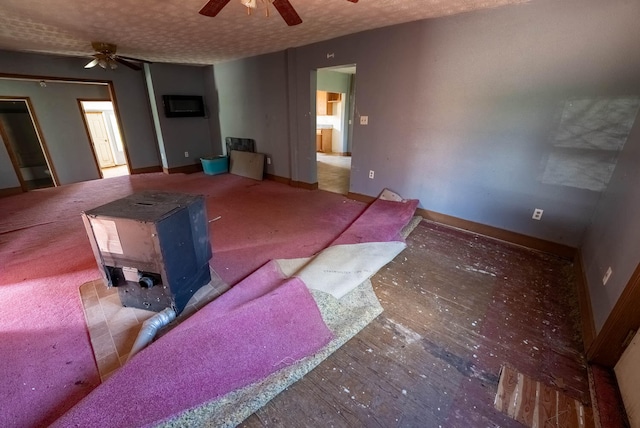 living room with ceiling fan and a textured ceiling