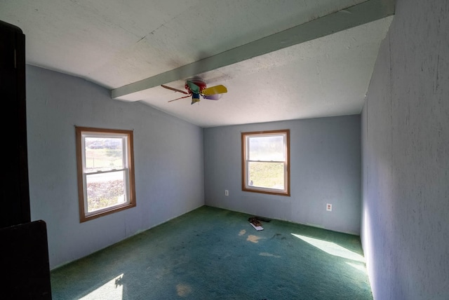 empty room featuring light carpet, vaulted ceiling with beams, and ceiling fan