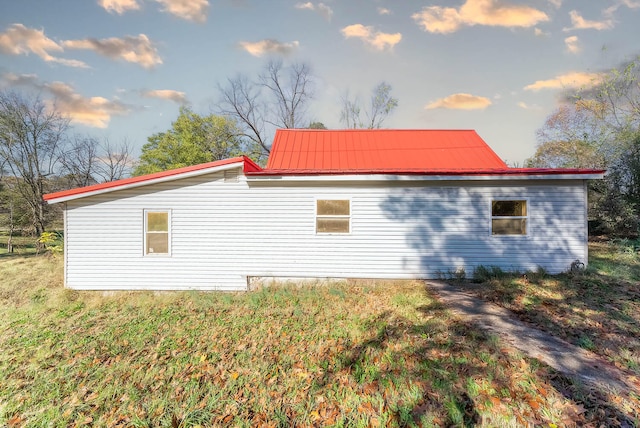 view of property exterior featuring a lawn