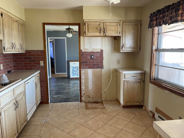 kitchen featuring stovetop, ceiling fan, light tile patterned floors, and dishwasher