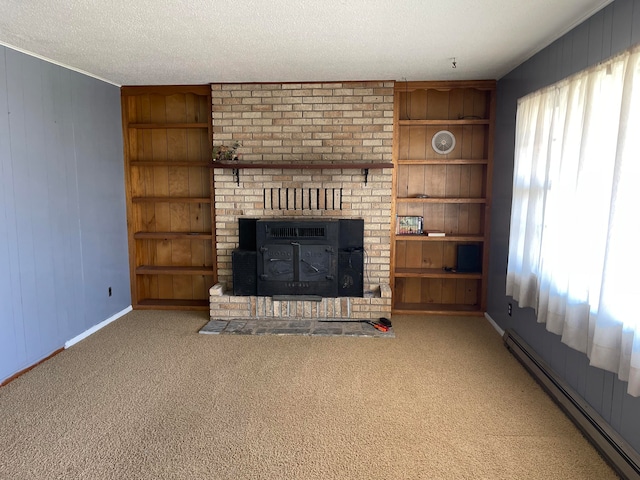 unfurnished living room featuring wood walls, baseboard heating, a textured ceiling, and carpet flooring