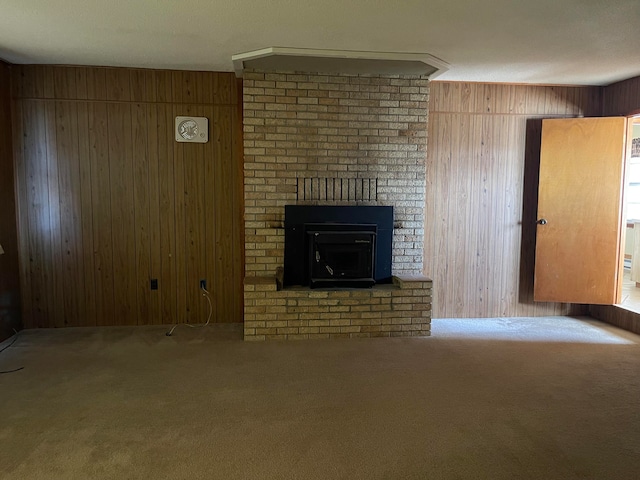 unfurnished living room featuring wood walls and carpet floors