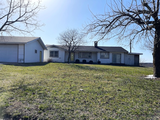 ranch-style home with a garage and a front lawn