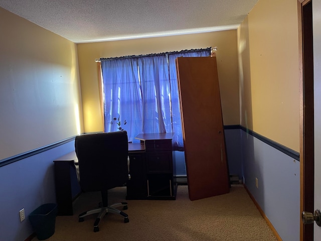 carpeted office space featuring a textured ceiling