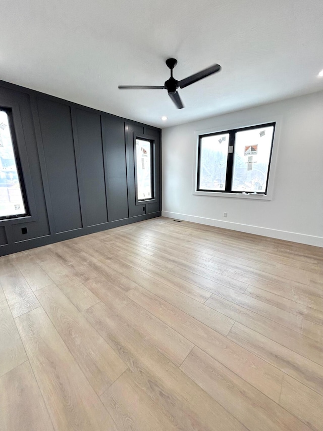 empty room featuring ceiling fan and light wood-type flooring