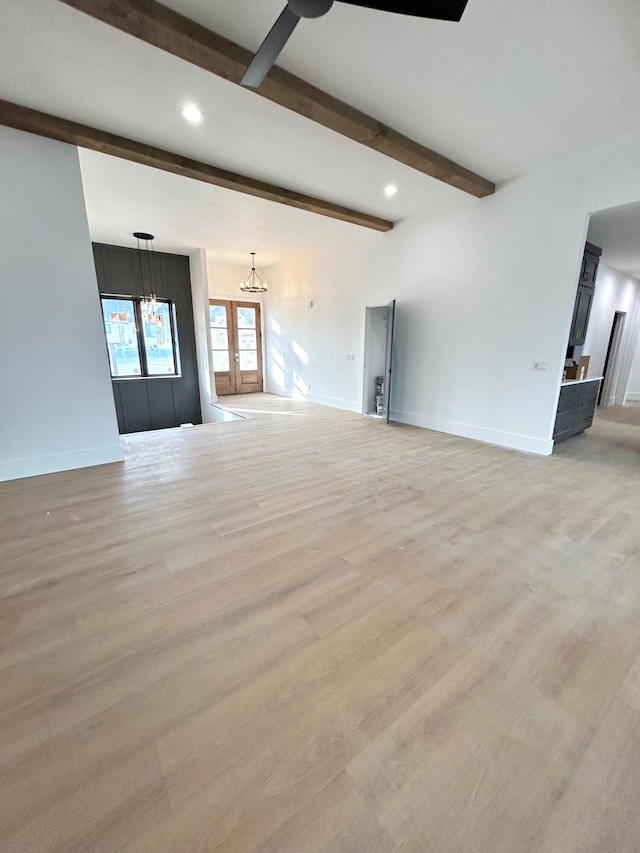 unfurnished living room with french doors, light hardwood / wood-style floors, and beam ceiling