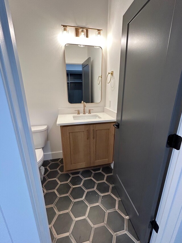 bathroom with vanity, tile patterned floors, and toilet