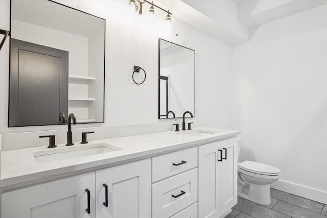 bathroom featuring vanity, tile patterned flooring, and toilet